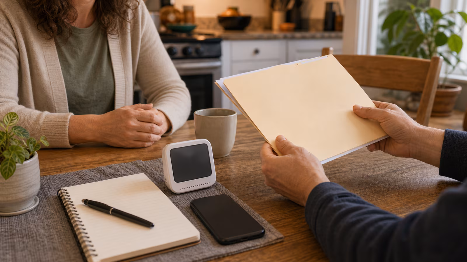 A kitchen table with symptom notes, carbon monoxide alarm, air monitor, phone for professional call, and purifier in background.