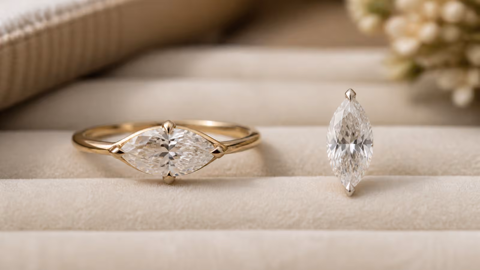 Marquise diamond engagement ring beside a loose marquise stone on a velvet tray.