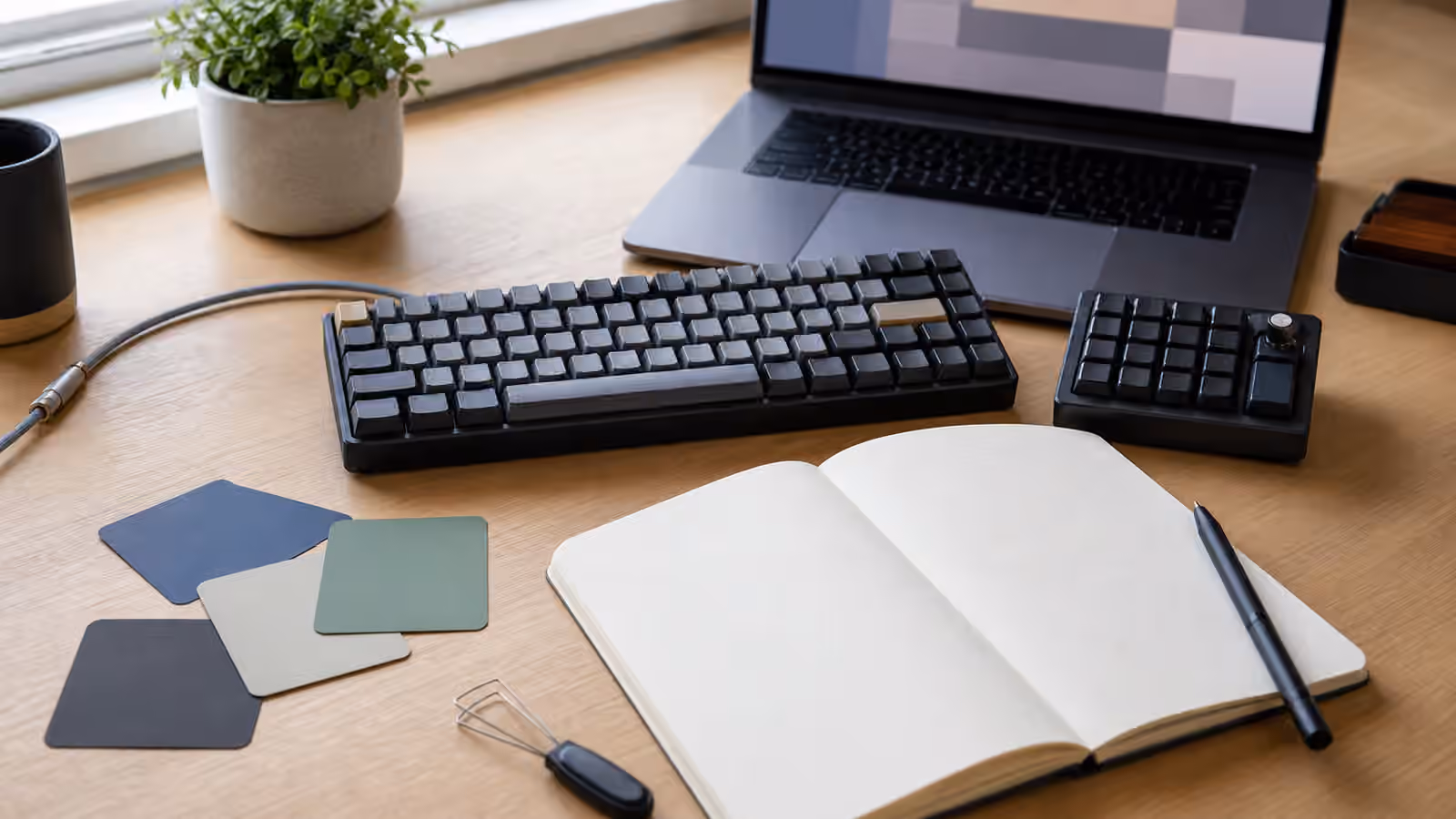 Programmable keyboard and macropad beside blank shortcut planning cards.