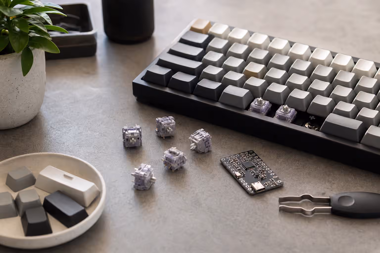 Mechanical keyboard with loose magnetic switches, blank keycaps, and a small unbranded sensor board.