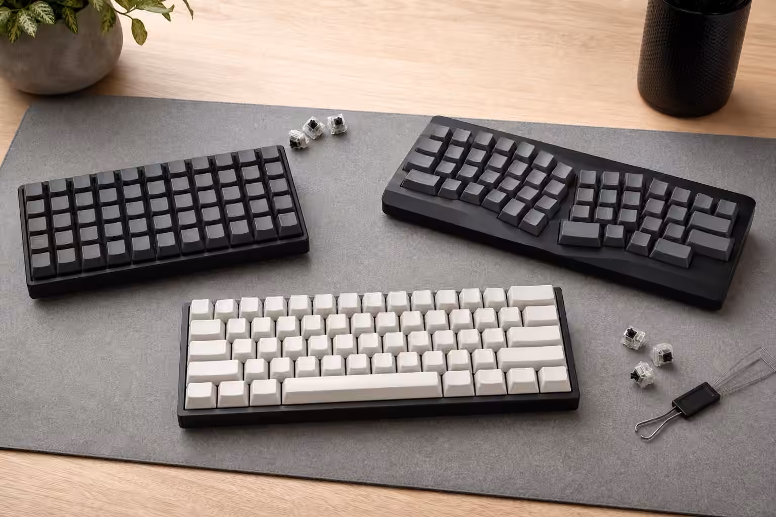 Ortholinear, column-staggered, and traditional compact keyboards arranged for comparison.