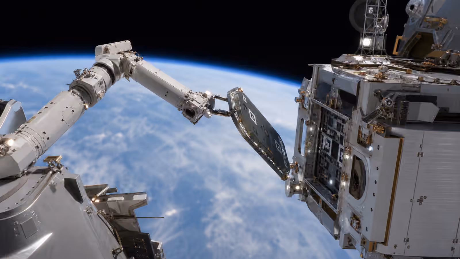 An unbranded orbital robotic arm carefully holds a replacement panel near a spacecraft interface above Earth.